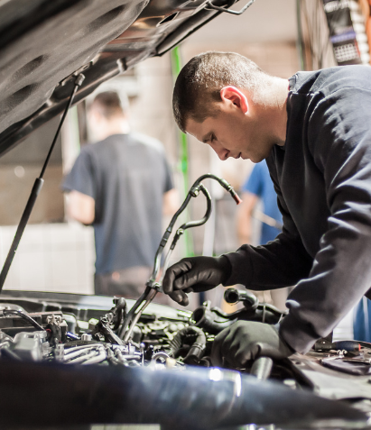 man working on car engine 